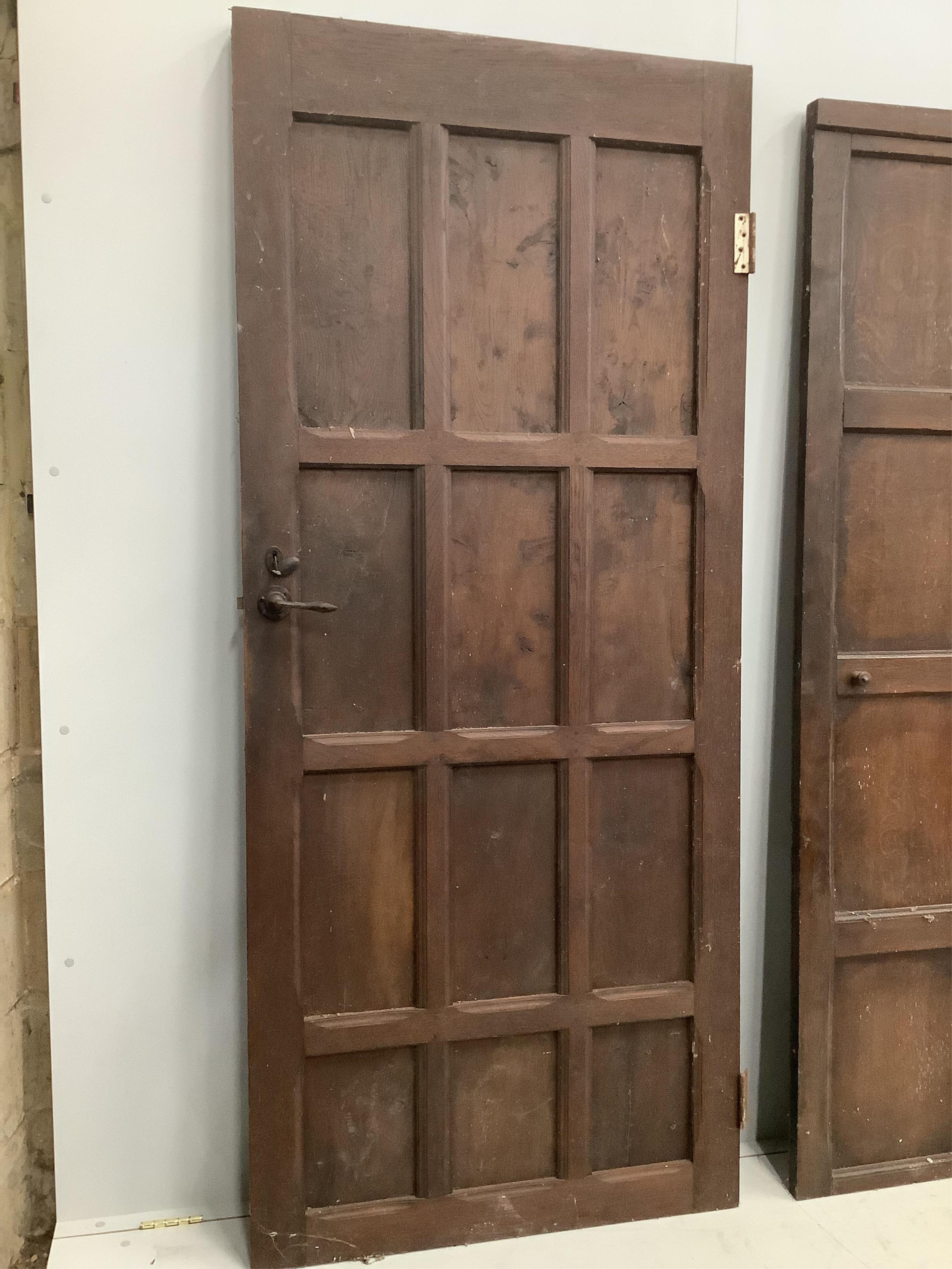 Three various panelled oak doors, largest width 107cm, height 181cm. Condition - poor to fair